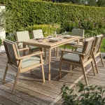 RHS Hampton 6 seat dining set on a garden decking with hedge