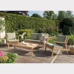RHS Hampton lounge set with 2 seater sofa and 2 armchairs on a garden decking with hedge