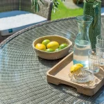 Harlow Carr glass top dining table detail with bowl of fruit on a garden terrace in the sunshine