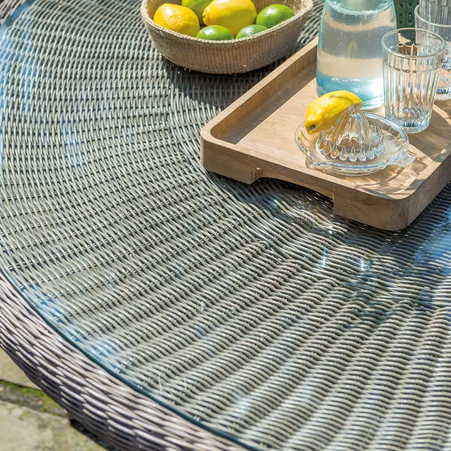 Harlow Carr glass top dining table detail on a garden terrace in the sunshine