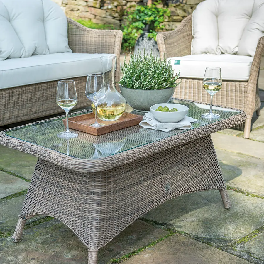 RHS Harlow Carr lounge glass top coffee table on a garden patio