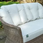 RHS Harlow Carr lounge 2 seater sofa with cushions on a garden patio