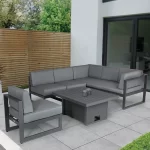 Versa corner lounge set with high low table in the low position on a grey garden patio
