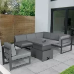 Versa corner lounge set with high low table in the up position on a grey garden patio