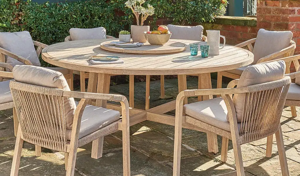 Wooden garden furniture dining set on a patio.
