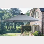 Wind up parasol in table on garden patio