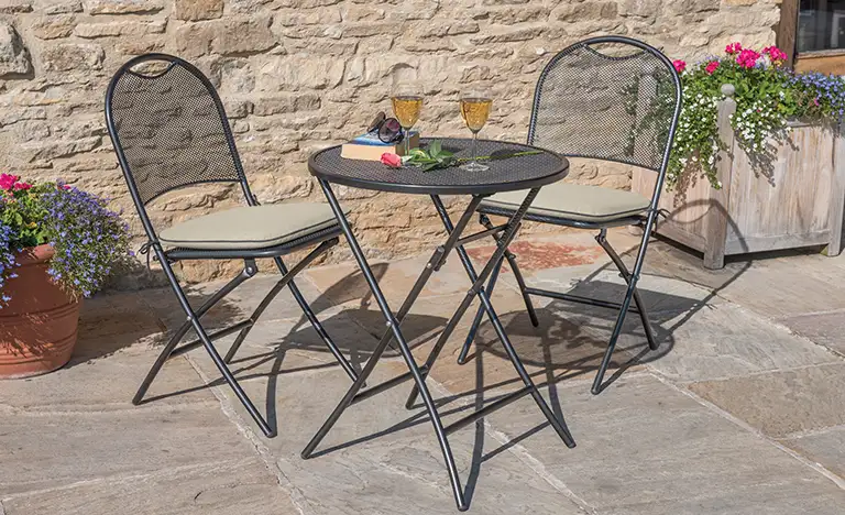 Metal Café Roma bistro set on a garden patio in the sunshine