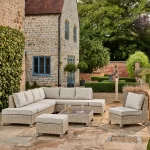 Palma low lounge corner set in oyster with stone cushions and fire pit table on a garden patio