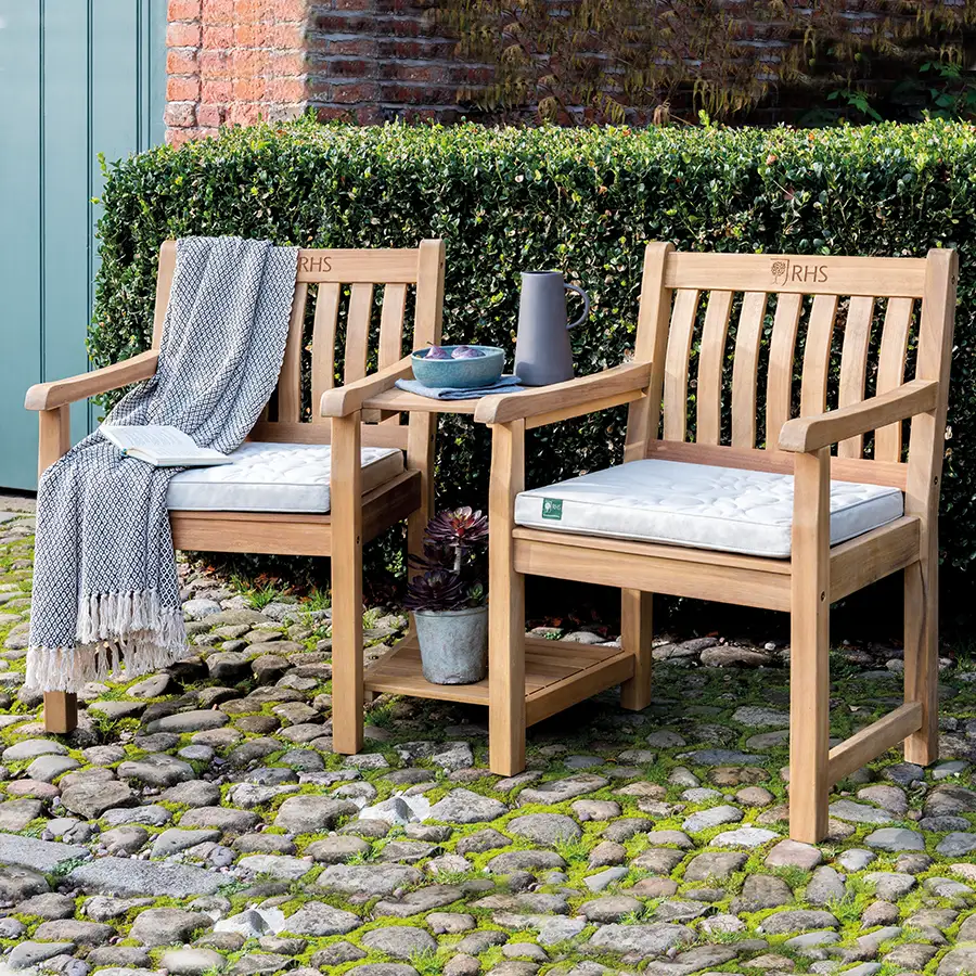 RHS Chelsea companion set with seat pads on a cobbled garden patio