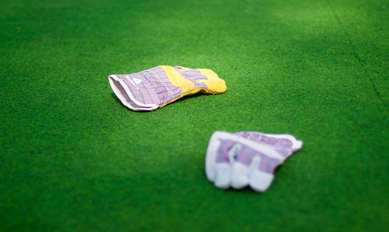 gardening gloves on an artificial lawn