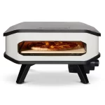 Cozze 13 inch electric pizza oven with a pizza cooking inside