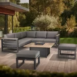 elba Signature Grande corner set and two footstools with table in the low postition on a wooden decking outside a modern home