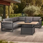 elba Signature Grande corner set with table in the high postition on a wooden decking outside a modern home