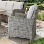 Palma Armchair in oyster with stone cushions in the garden on a summers day