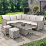 Palma Signature Corner Right Hand in oyster with glass top high/low table on a stone patio in a country garden