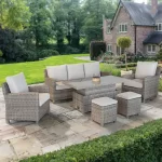 Palma Signature Sofa Set in Oyster with a glass top table in the up position in the beautiful garden of a country house