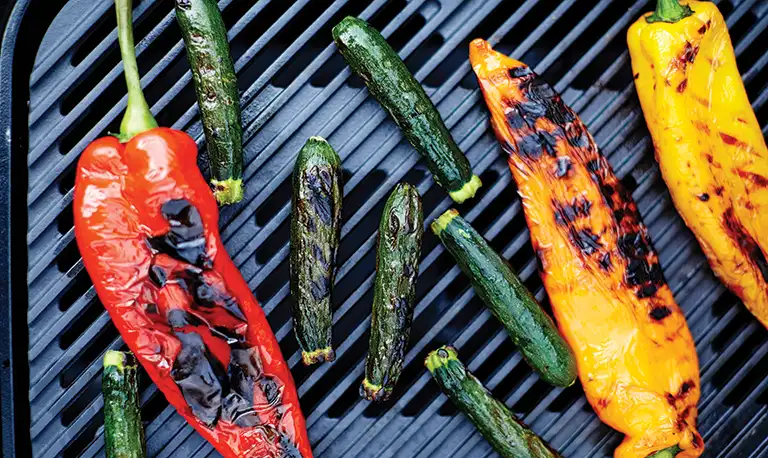 Grilled vegetables cooking on a gas bbq