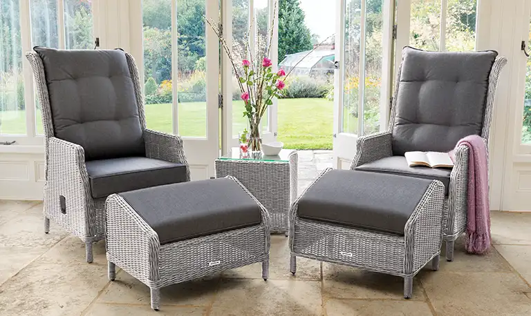 Two Kettler Palma recliners with footsools in a conservatory
